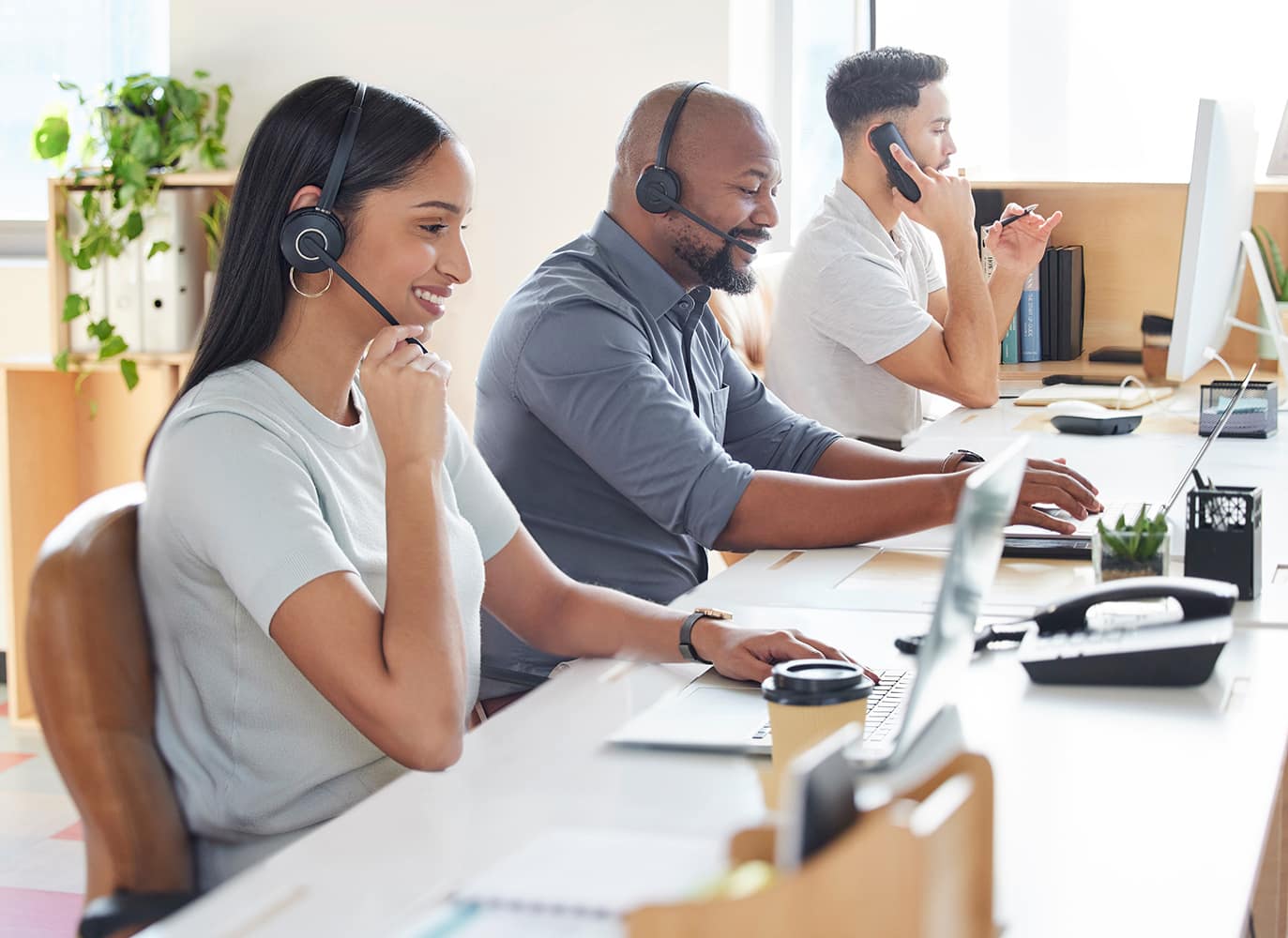 Shot of a group of businesspeople working in a call centre. Shot of a group of businesspeople working in a call centre.
